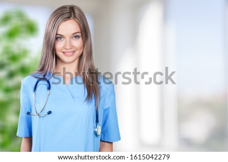Portrait smiling female doctor nurse in blue uniform with stethoscope