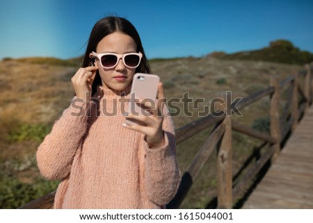 teenage girl with pink wireless headphones