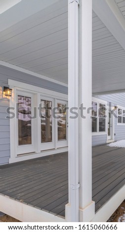 Vertical frame Exterior wooden covered patio in winter snow