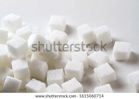 high key Closeup of a Pile of sugar cubes randomly arranged on a white background