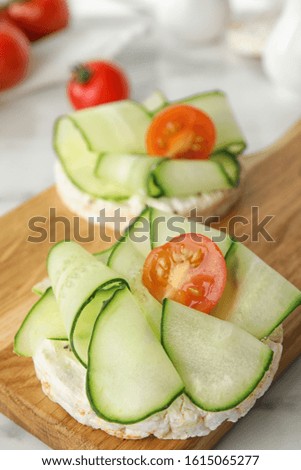 Puffed rice cakes with vegetables on table, closeup