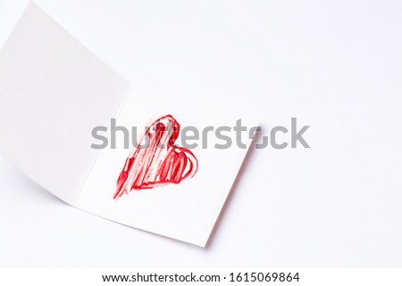 Lipstick-painted red heart on greeting card. Happy Valentines day,Mothers day,Womens day,wedding card. Top view, flat lay, copy space. Horizontal orientation