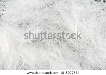 Close up, top down view of monofilament micro polypropylene fiber for concrete structural reinforcement. Construction themed macro background Royalty-Free Stock Photo #1615079341