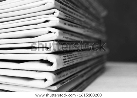Stack of newspapers on white table, closeup. Journalist's work