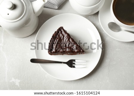 Tasty chocolate cake served on grey marble table, flat lay