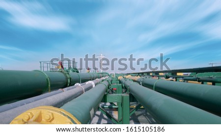 close up green pipe line, Tubes running in the direction of the setting blue sky, pipe line transportation is most mammon way of transporting goods such as oil, natural gas or water on long distance Royalty-Free Stock Photo #1615105186