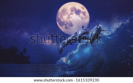 Beautiful night ocean with playful dolphins leaping on surfing wave and full moon on tropical background, mixed media Royalty-Free Stock Photo #1615109230