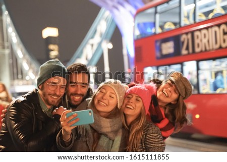 Group of best friends having fun on city street. Group of student people making photos and selfies on the big bridge. Travel and friendship concept - Image