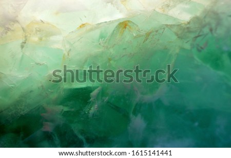 A close up picture of green jade though the light, the pattern of the jade is like dreamy mountain made by ice. Can be used as background of natural, green topic. Royalty-Free Stock Photo #1615141441