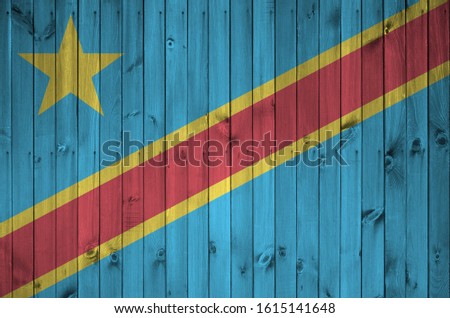 Democratic Republic of the Congo flag depicted in bright paint colors on old wooden wall. Textured banner on rough background