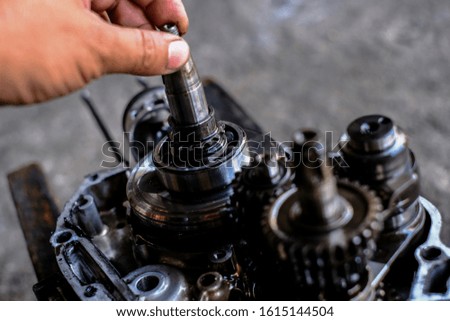 Repairman disassemble motorcycle engine, motorcycle