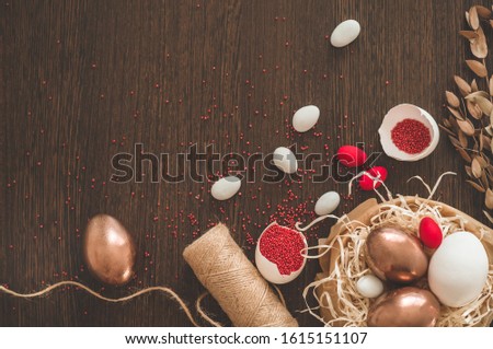 Happy Easter. Flat Lay of Golden Eggs and easter red sprinkle on wooden background. Easter concept