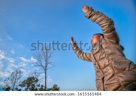 Man lift hands praying at mountain. christian concept.