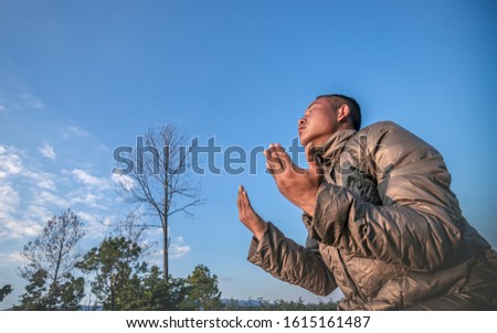 Man praying at mountain. christian concept.