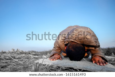 Man kneeling down and praying on mountain. christian concept.