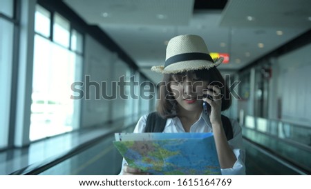 Beautiful girls are traveling using a map to search for tourist attractions.