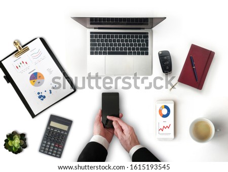 Businessman using smartphone. Office desk top view