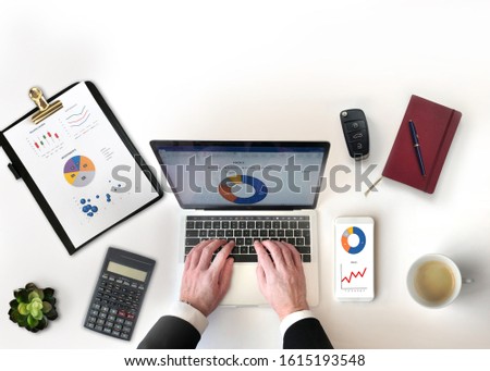 Businessman typing on laptop. Office desk top view