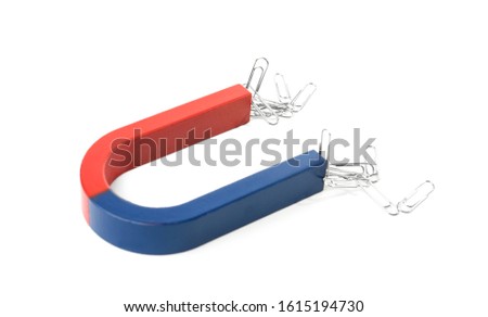 Magnet attracting paper clips on white background