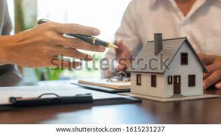 House model with agent and customer discussing for contract to buy, get insurance or loan real estate or property. Royalty-Free Stock Photo #1615231237