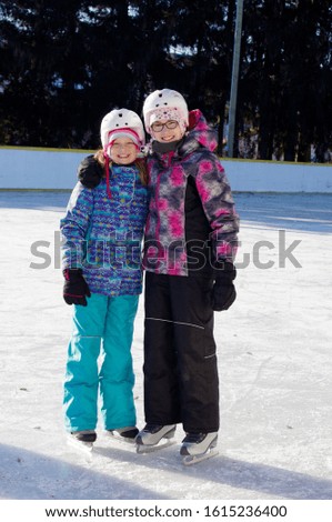 girls skating on outdoor rink