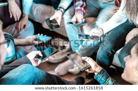Friends having addicted fun using mobile smart phone at home - Close up of people hands sharing photos on social media network with smartphone - Technology concept with milenials online with cellphone Royalty-Free Stock Photo #1615261858