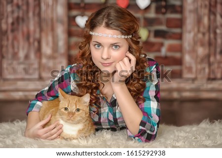 Beautiful teen girl with a cat in hands