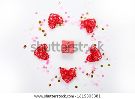 Handmade gingham Love Valentine's hearts on red cord with clips hanging on wooden background, copy space
