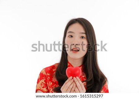 the asian young little girl dressed in chinese traditional fastival outfit wishing luck for the Chinese new year holiday isolated white background copyspace