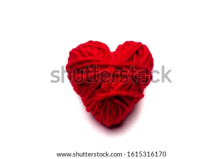 red knitted heart for Valentine's day on a white background, isolate .close up