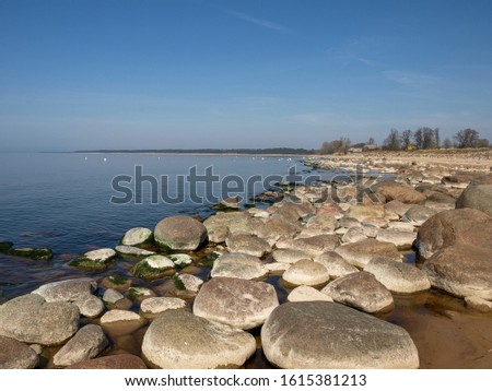 picture with rocks and beach on peaceful sea shore