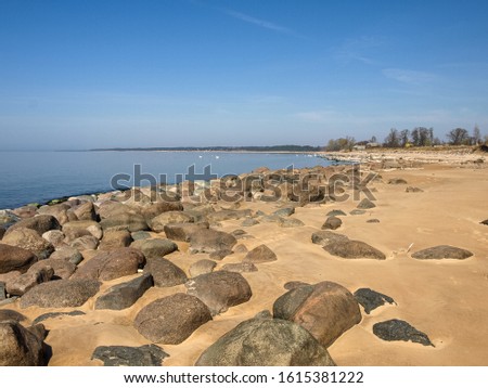 picture with rocks and beach on peaceful sea shore