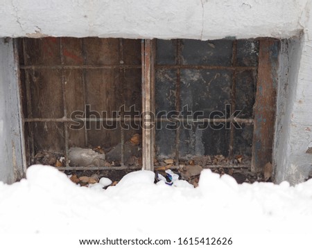 The window in the basement of an old house. Groomed and dirty. Royalty-Free Stock Photo #1615412626
