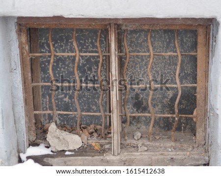 The window in the basement of an old house. Groomed and dirty. Royalty-Free Stock Photo #1615412638