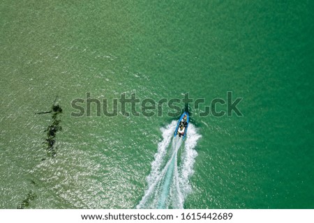 Aerial Image of Rib speeding through shallow sea