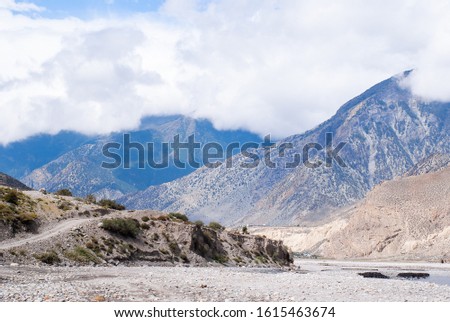 Picture of rocky Himalayan landscape with road and footpath, trekking in Nepal, Annapurna circuit trek
