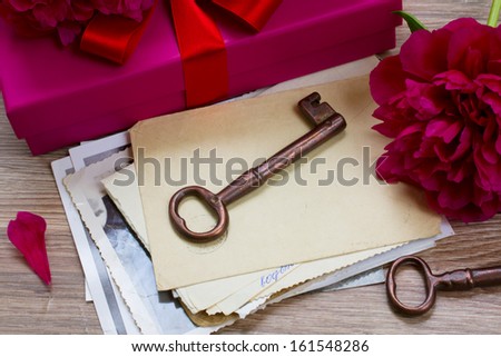 vintage key and old mail  on a wooden table