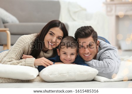 Happy family with little son spending time together at home. Winter vacation
