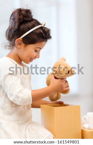 holidays, presents, christmas, x-mas, birthday concept - happy child girl with gift box and teddy bear