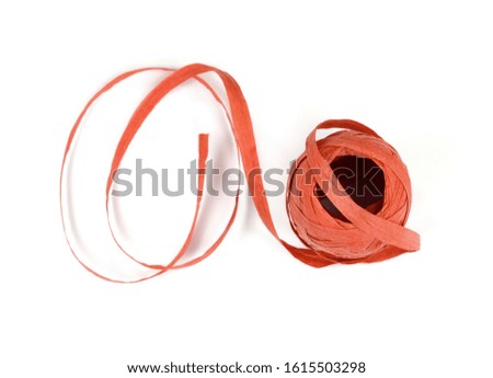 Paper Red ribbon roll isolated on white background