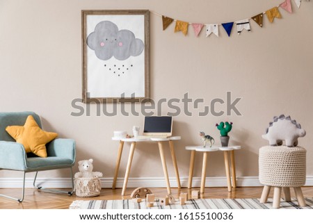 Stylish and beige scandinavian decor of kid room with mock up poster frame, design furnitures, natural toys, hanging colorful flags, plush animal, child accessories and teddy bears. Natural home decor