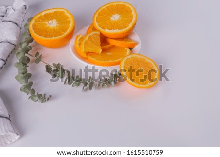 Sliced citrus fruit on white background. Fresh orange citrus fruit with leaves. Space for text.