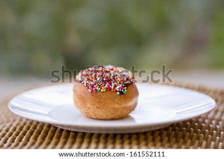 Colorful donut over blurred green background for Jewish Holidays of Hanukkah.