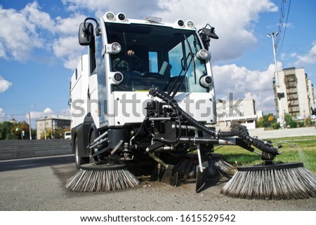 Car - vacuum cleaner and sweeper for cleaning city streets. Municipal economy and improvement. Machines and mechanisms.