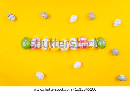 Colorful easter painted eggs background on yellow pastel color background with space. Easter holiday concept. Traditional decoration for springtime holiday. Top view easter greeting card