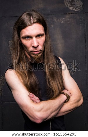A guy with long hair. Emotions Portrait.
