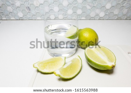Creative concept shot of lemon water concept made from green lemons and alternative compositions of healthy lifestyle lemon water weighing alternative compositions prepared from lemon in water in glas