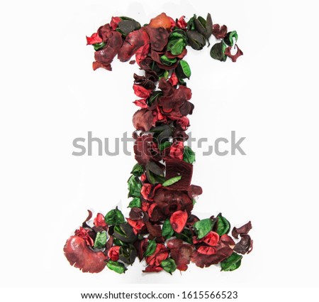 Latin alphabet letter made from dry rose flowers.