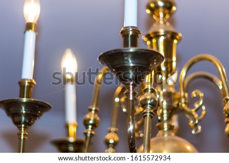 Picture of a chandelier in golden color and a closed photo