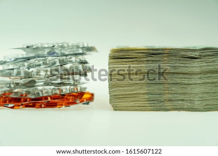 A stack of banknotes and empty medicine packagings